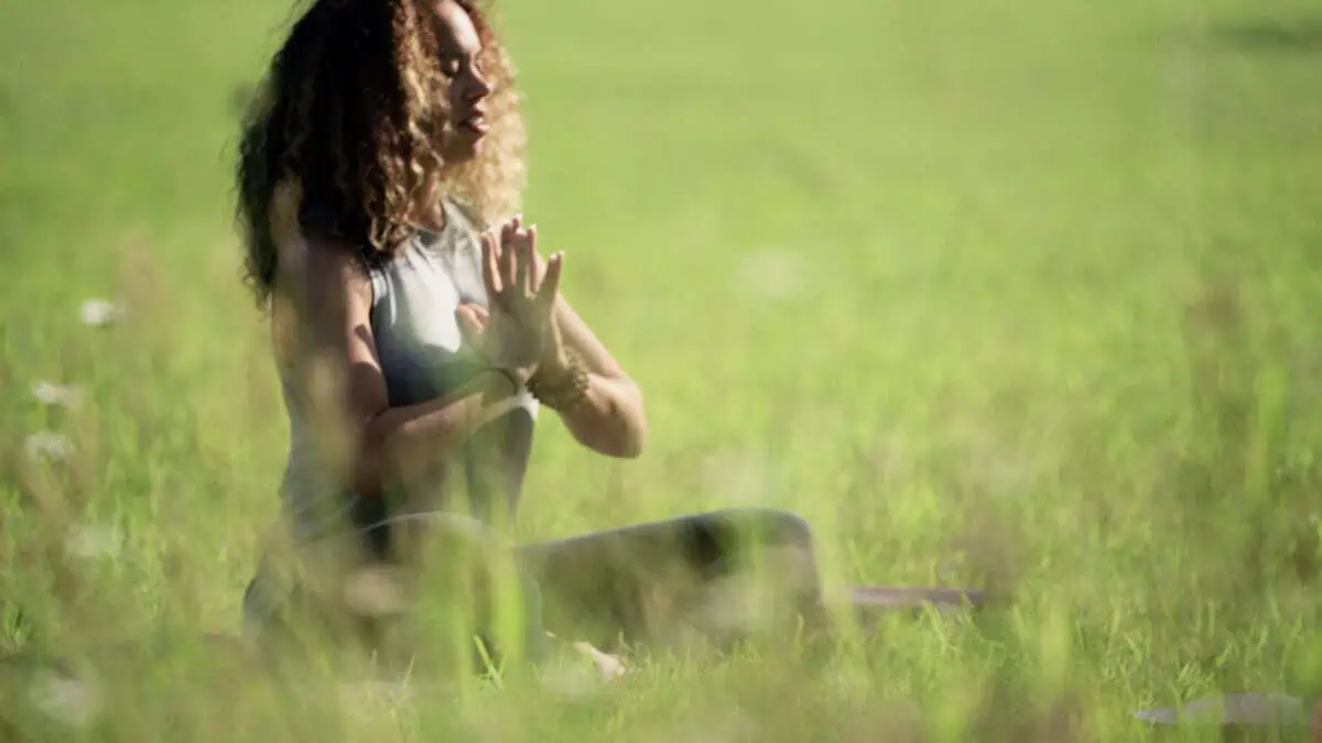 A woman practices meditation as part of a mental health workshop.