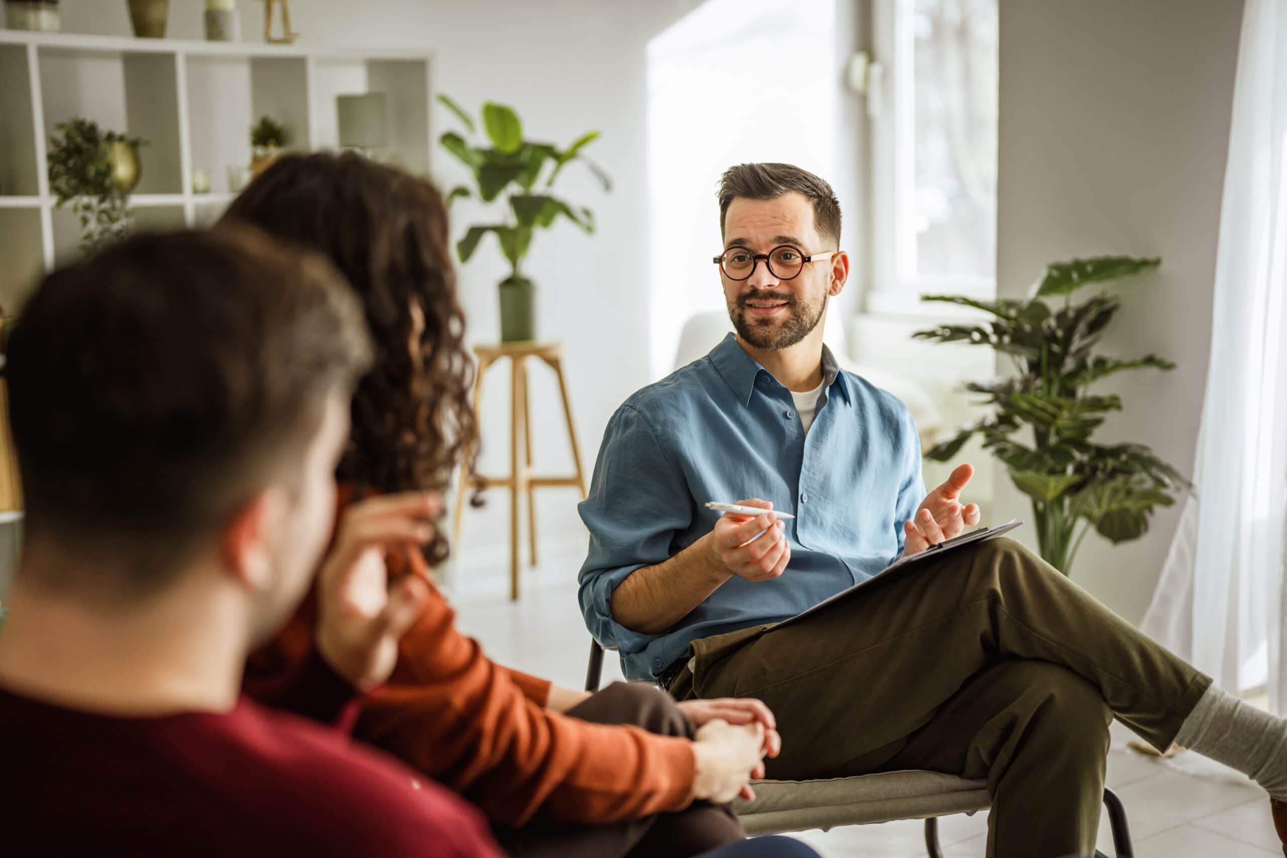Group of people talking in therapy at hancock county mental health​.